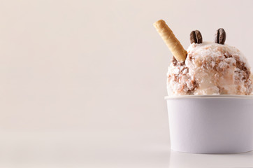 Coffee ice cream cup on table isolated close up