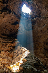 the Sun beam light through hole in the cave at thailand