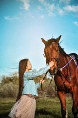 Fototapeta premium Beautiful girl with horse on the grass. Friendship concept.