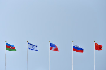 Naklejka premium Five flags India, Israel, America, China and Russia against the sky. Symbol of partnership and friendship between countries. Multipolar world and equality