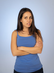 Portrait of unsatisfied latin teenager young woman looking worried with concern face