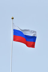 Beautiful and bright flag of the Russian Federation against the sky.