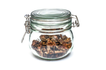 cut dry root of Rhodiola rosea in a glass jar on natural white background