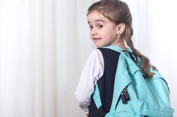 girl elementary school student on a light background