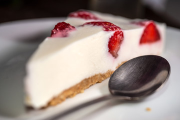 Rustic still life with a strawberry cheesecake