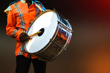 A person playing Drumhead, -Drumhead is a musical instrument that is sounded by being struck or...