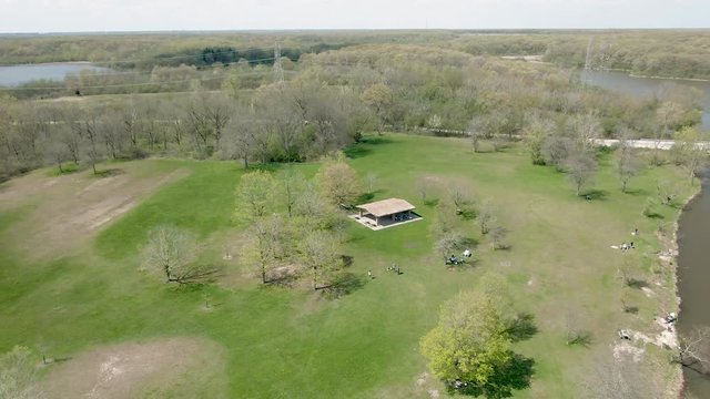 Aerial circular motion around a pavilion in a public park near a lake. Tampier Slough Woods in the western suburbs of Chicago, Illinois, near Lemont.