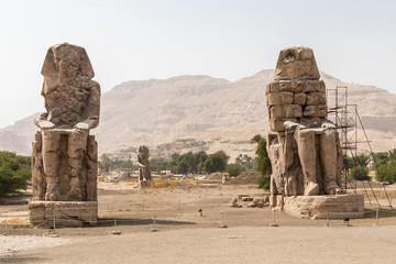 Two stone statues of Pharaoh Amenhotep III at Thebes Necropolis, Luxor, Egypt