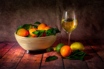 In the style of the old masters still life, a citrus fruit combination of lemons, limes and satsumas.