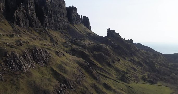 Aerial shot of cliffs and rocky terrain at Trotternish peninsula in Isle of Skye, Scotland.