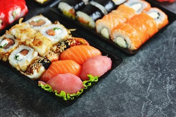 Sushi set with salmon, soft cheese, tuna, smoked eel. Sushi delivery to home. Healthy food. Top view. 