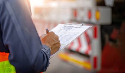 Preforming a pre-trip inspection on a truck,Concept preventive maintenance truck checklist,Check truck engine,Check the lubricating oil,spot focus.