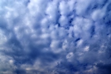 Beautiful white fluffy clouds on a deep blue sky in high resolution