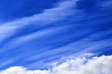 Beautiful white fluffy clouds on a deep blue sky in high resolution