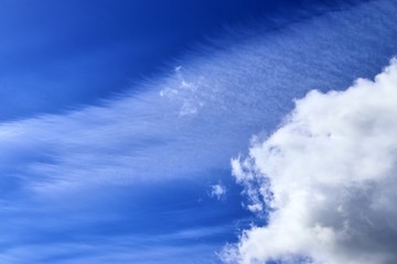 Beautiful white fluffy clouds on a deep blue sky in high resolution