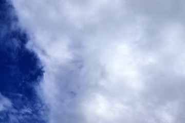 Beautiful white fluffy clouds on a deep blue sky in high resolution