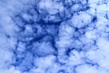 Beautiful white fluffy clouds on a deep blue sky in high resolution