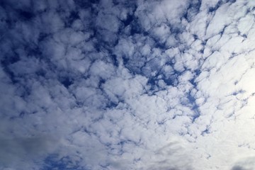 Beautiful white fluffy clouds on a deep blue sky in high resolution