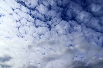 Beautiful white fluffy clouds on a deep blue sky in high resolution