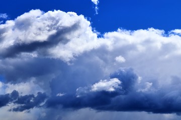 Beautiful white fluffy clouds on a deep blue sky in high resolution