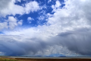 Beautiful white fluffy clouds on a deep blue sky in high resolution