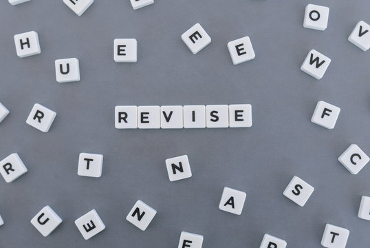 Revise Word Made Of Square Letter Word On Grey Background.