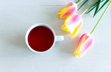 Colorful tulips with cup of coffee . Home. Spring flowers. Spring background. Greeting card for Valentine's Day, Woman's Day and Mother's Day.