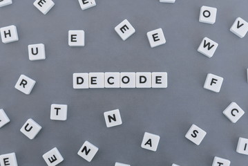 Decode word made of square letter word on grey background.