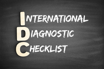 Obraz premium Wooden alphabets building the word IDC - International Diagnostic Checklist acronym on blackboard