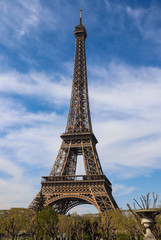 Fototapeta na wymiar Eiffel Tower in Paris France against blue sky with clouds. April 2019