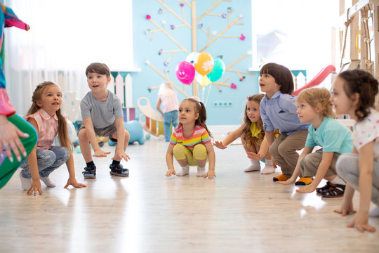 Cute children kids boys and girls squat playing roundelay