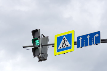Green color on the traffic light. Sign of a pedestrian crossing.