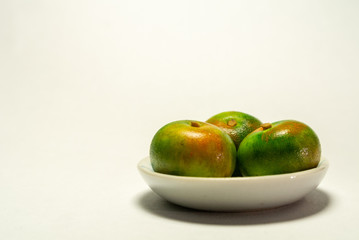 orange in bowl isolated on white background