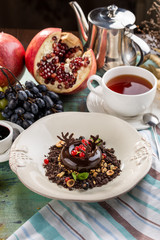Black Forest chocolate dessert with cup of tea on textile napkin