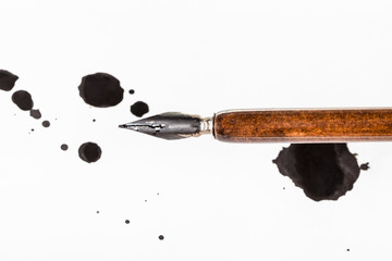 brown dip pen and black ink blots on white paper