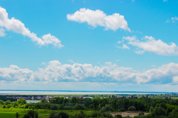 Cloudy sky above the water reservoir background. Abstract fpuffy cloudscape