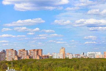blue sky with clouds over city park in spring