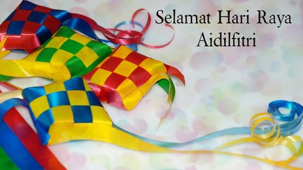 Greeting with malay word "Selamat Hari Raya Aidilfitri" that translates to wishing you a joyous hari raya on ketupat ribbon background. Selected focus. Image flare, soft, bokeh and vintage.
