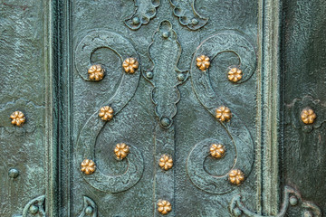 Ancient  gate with metal mounting and ironworks.  Beautiful decorative metal elements forged...