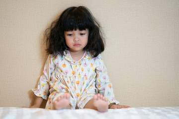 Upset lonely bullied little Asian kid girl looking away feels abandoned abused, sad and alone.
