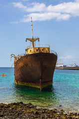 Close up view of ship wreck of Temple Hall with the Port of Arrecife in background