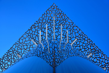 Lacy Carving Concrete Structure Over Glass Facade