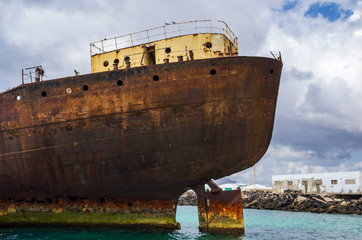 Close up view of ship wreck of Temple Hall with the Port of Arrecife in background