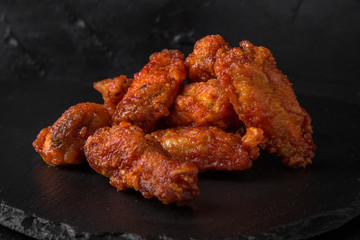Spicy Wings on black background. Snack to beer. Fast food.