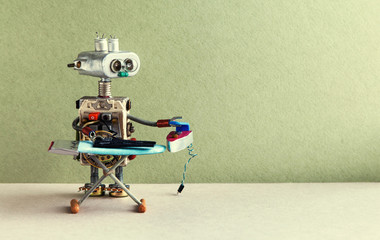Home cleaning and robotic ironing service concept. Domestic robot ironing black trousers with iron...