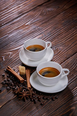 Two cups of espresso coffee on wooden table