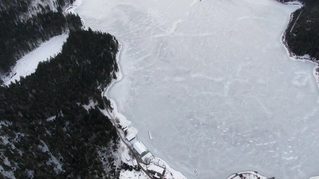 Aerial footage of a massive frozen lake Eibsee in Germany, 4k