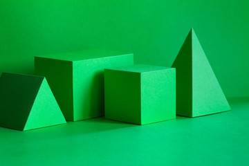 Green geometrical figures still life composition. Three-dimensional prism pyramid rectangular cube...