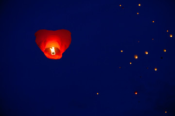 The Chinese lantern flies up highly in the sky.