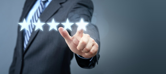 Businessman pointing to five star service rating symbol